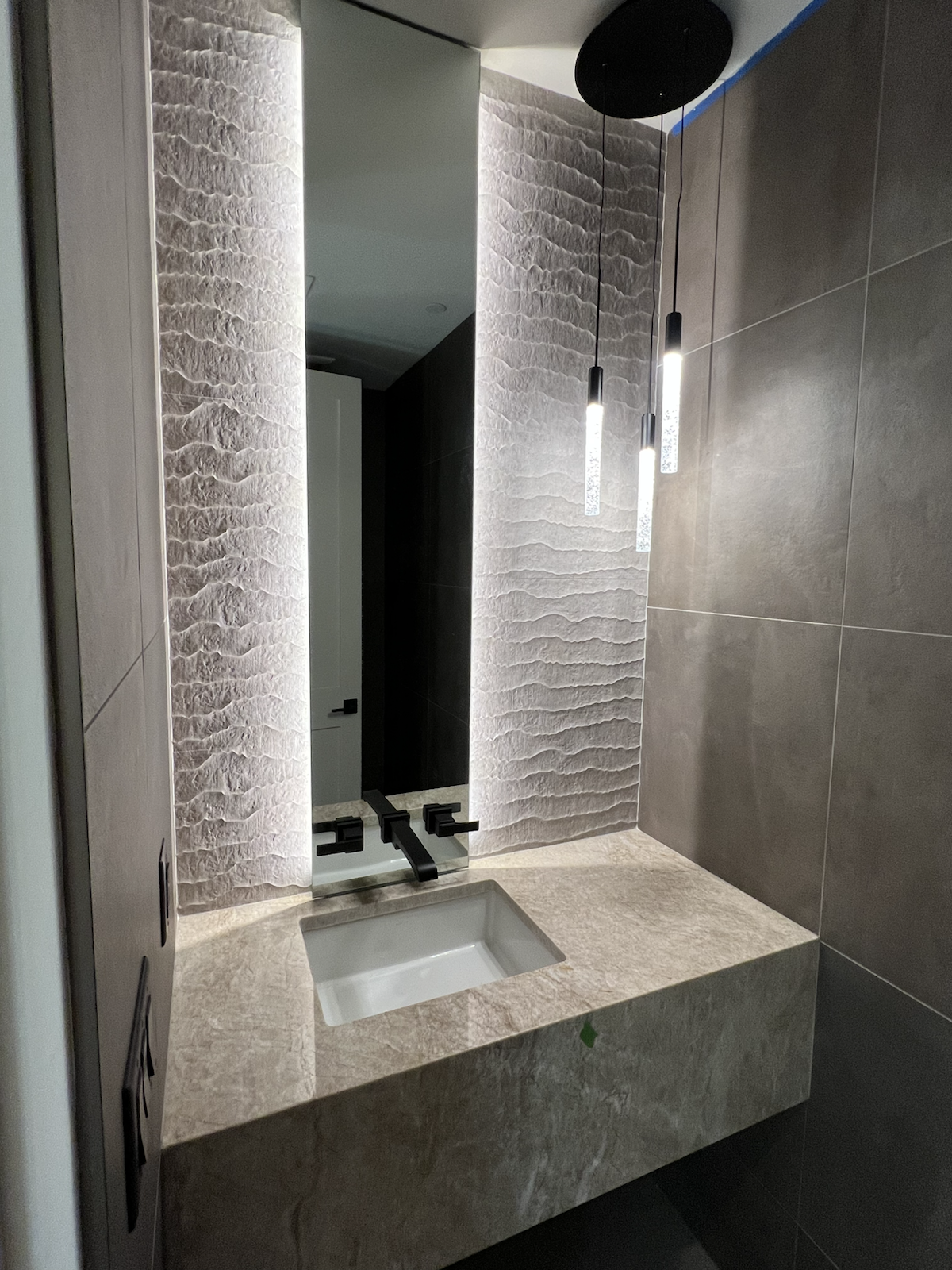 Custom sconce lighting at a bathroom vanity